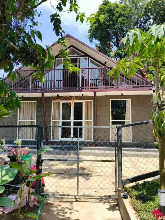 a house with a fence in front of it at Mount Homestay in Nedukandam