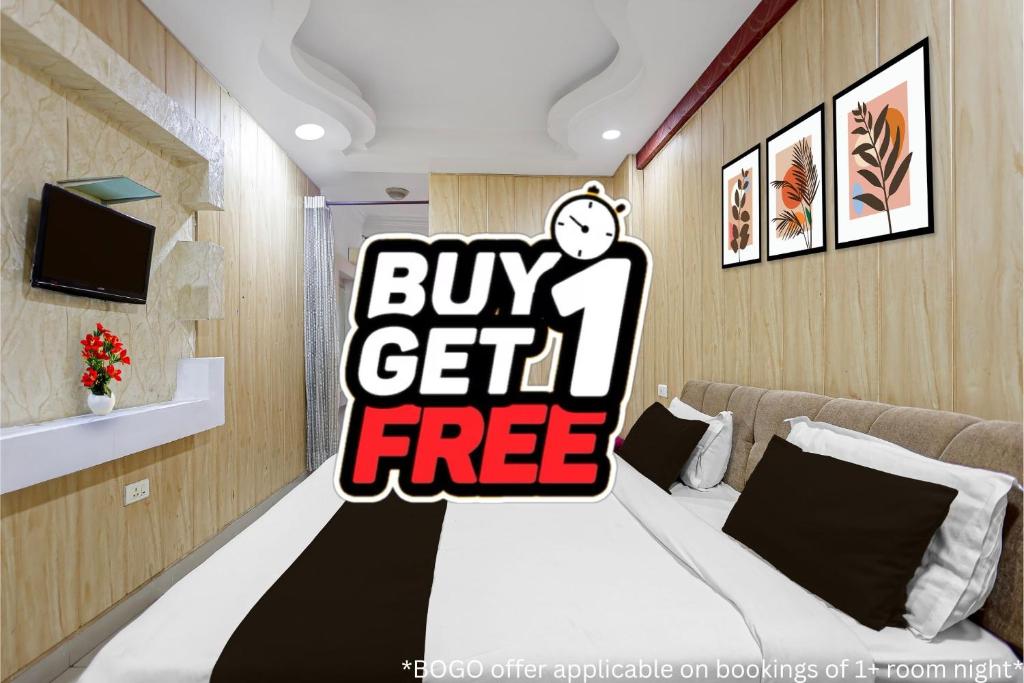 a room with a bed with a buy get free sign at Collection O Charbagh Metro Station Lucknow Formerly Seven Seas in Lucknow