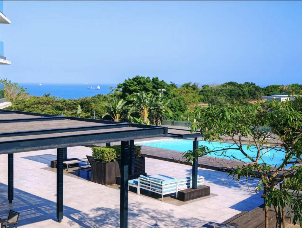a view of a swimming pool from a resort at Luxury Coastal Escape Coral Point Sibaya Pool & WiFi in Durban