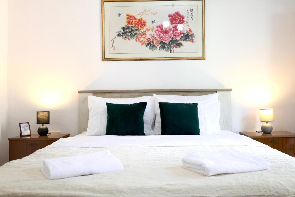 a bedroom with a white bed with two pillows on it at Doricera in Kotor