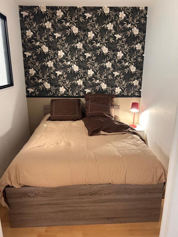 a bedroom with a bed with a black and white wallpaper at Boismortier in Thionville