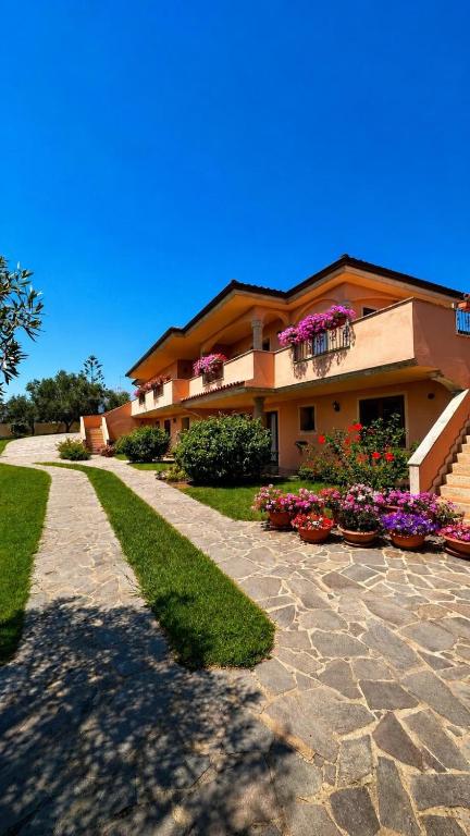 a building with flowers on the side of it at Stella Marina in Olbia