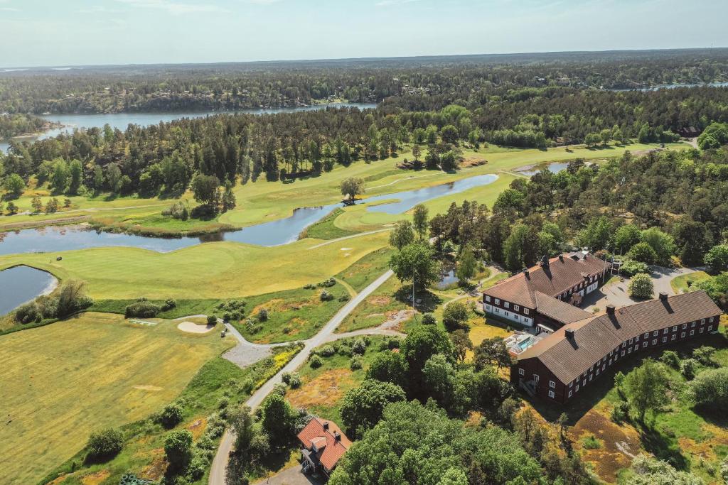 an aerial view of a golf course with a bridge over a river at Fågelbro Säteri in Värmdö