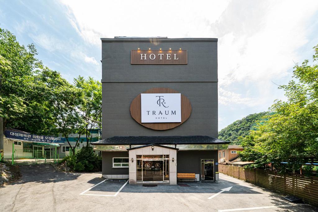 a hotel with a sign on the side of a building at Hotel Traum in Gapyeong