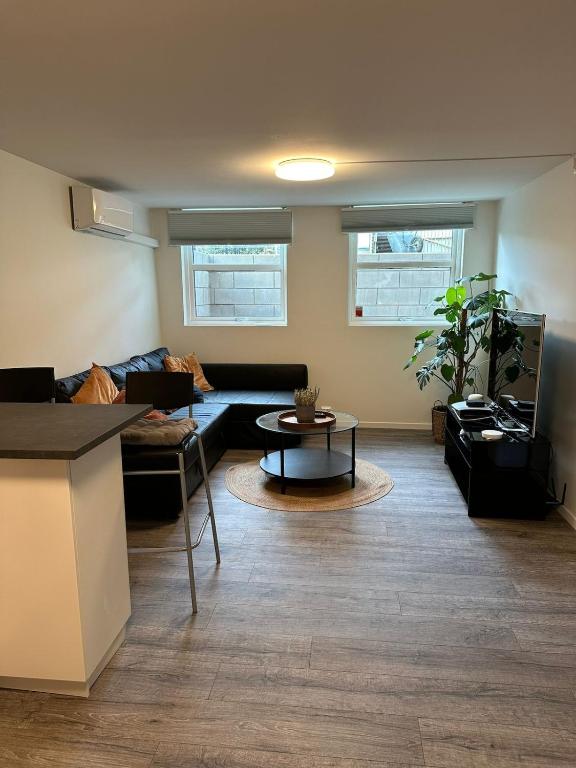 a living room with a couch and a table at Cozy apartment in Tananger close to the Airport in Tananger