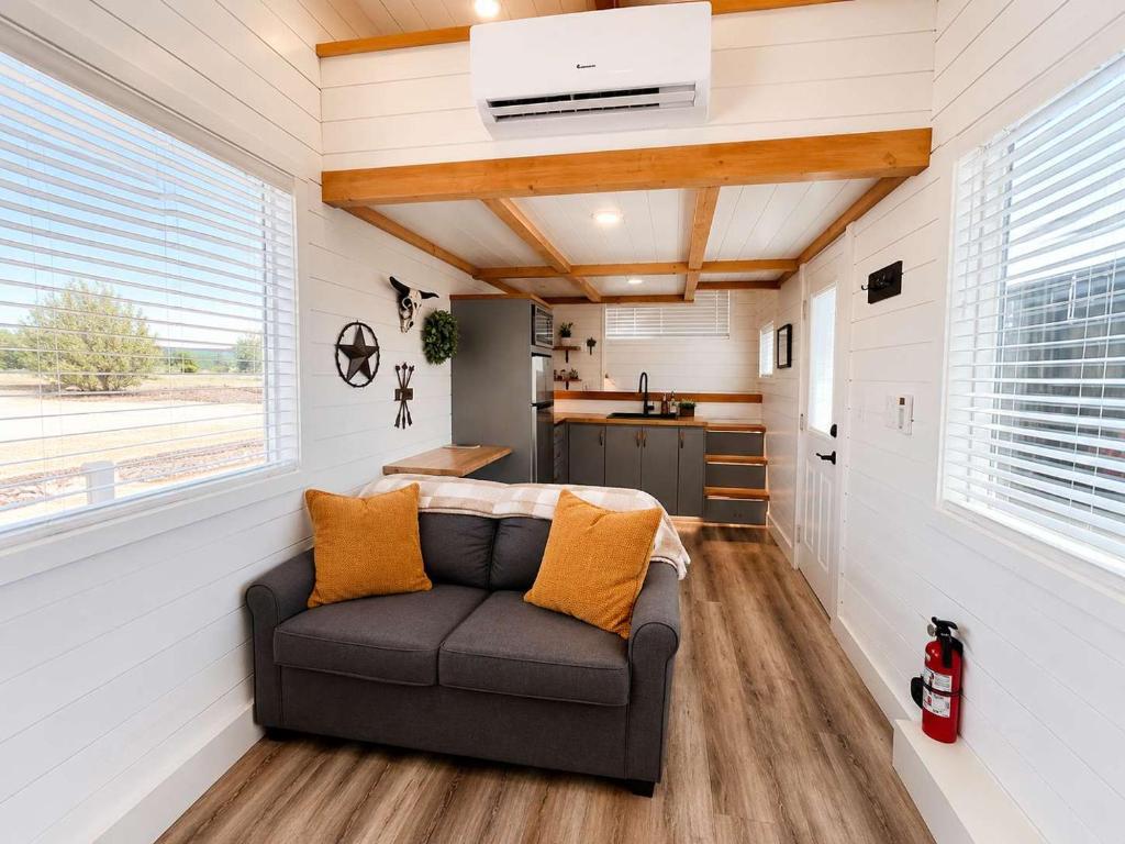 a living room with a couch in a tiny house at Zion Couples Retreat Romantic Desert Tiny Home in Apple Valley