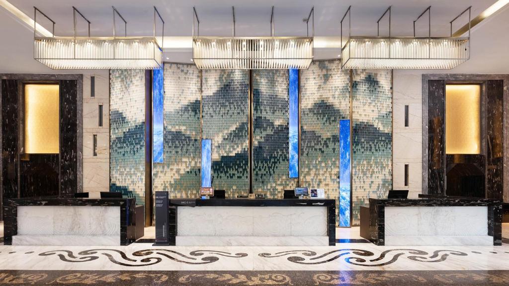 a room with three chandeliers and a wall of glass at Crowne Plaza Dujiangyan by IHG in Dujiangyan