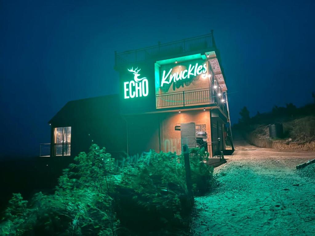 a restaurant with a neon sign on the side of it at ECHO Knuckles Nature Resort in Hunnasgiriya