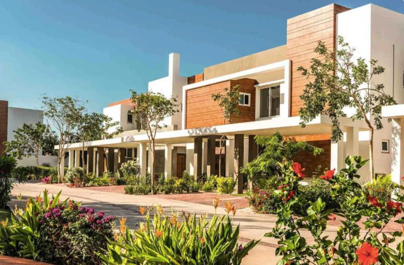 a building with a lot of plants in front of it at Modern House Surrounded By Nature in Mérida