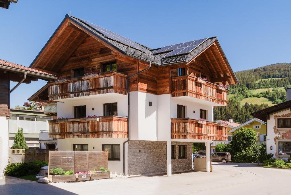 a house with wooden balconies and a roof at Appartementhaus Reiter in Altenmarkt im Pongau