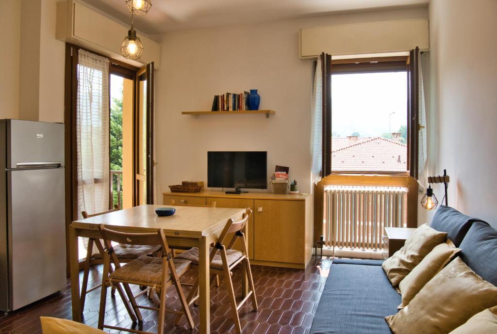 a living room with a table and a refrigerator at Barzio Coldogna 5 in Barzio