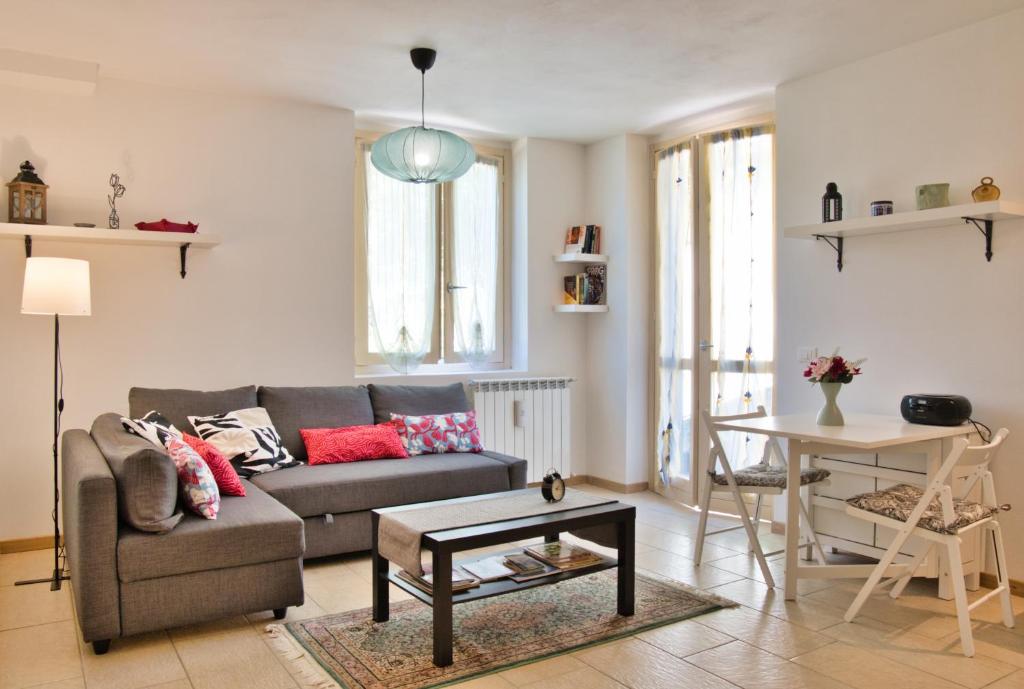 a living room with a couch and a table at Alpine studio Barzio in Barzio