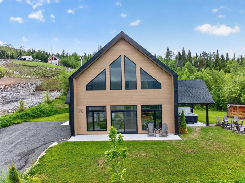 a house with a large window on the side of it at Panoramic View - Spa - L'Espace-temps in Saint Come