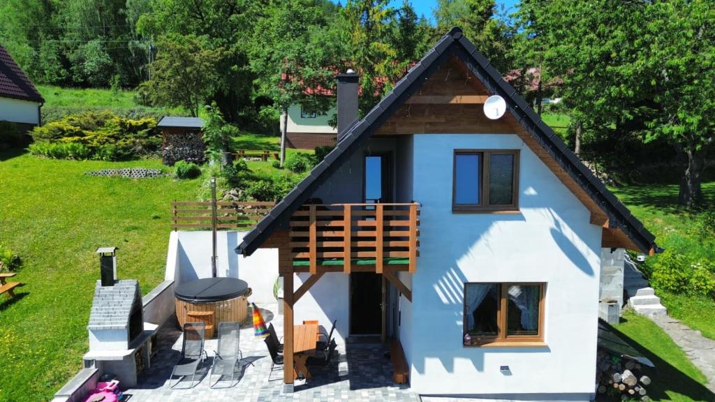 an aerial view of a tiny house with a porch at Domek Pod Lasem in Lipowa
