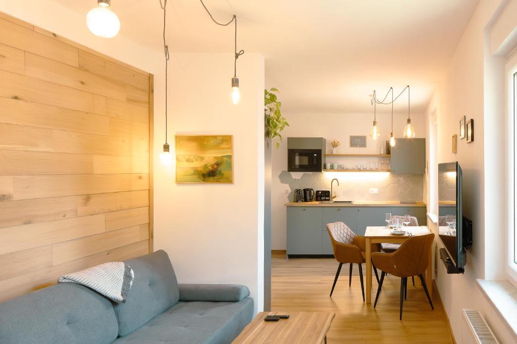 a living room with a blue couch and a table at Geidorf Residenz - Serviced Apartments & Parking in Graz
