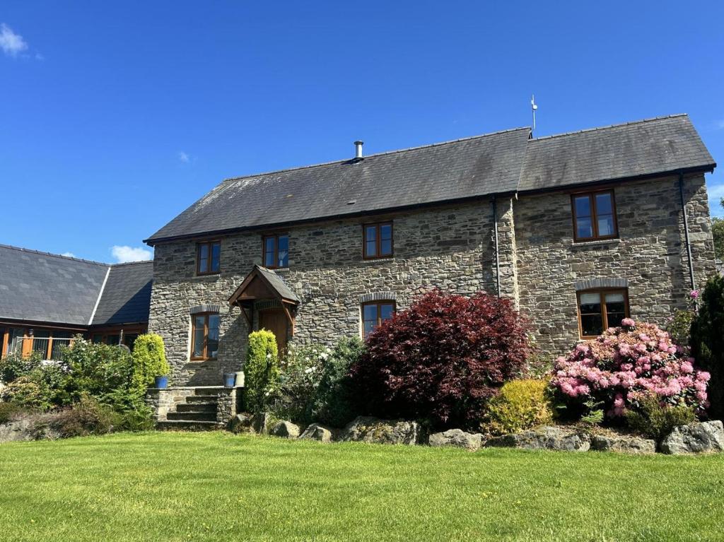 a large stone house with a yard at 5 Bed in Garth oc-c44957 in Garth