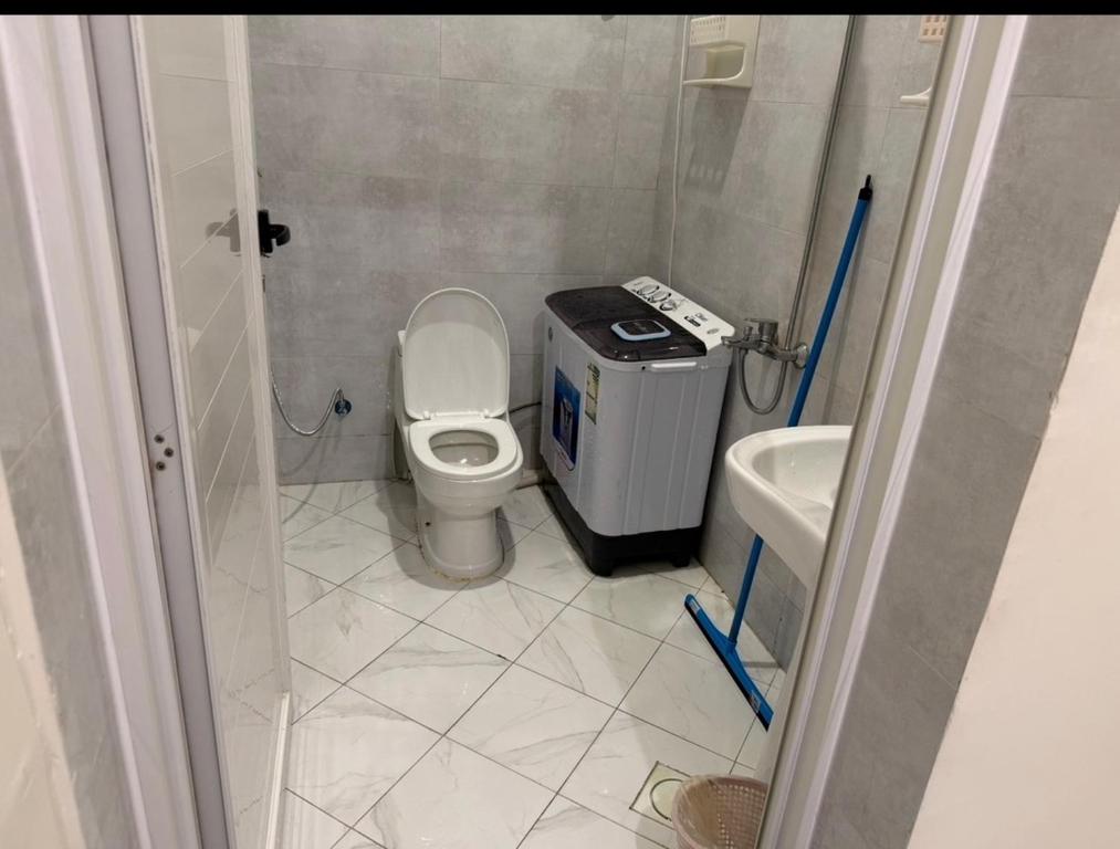 a small bathroom with a toilet and a sink at سويت لافندر in Abha