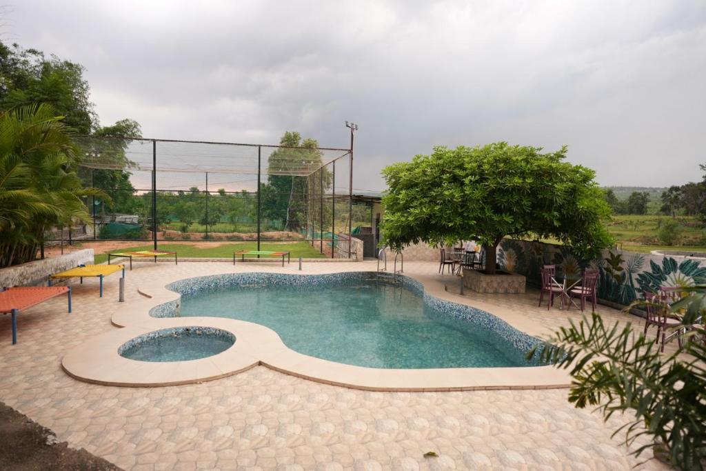 a swimming pool in the middle of a park at Mount Magica - Refined By Nature in Rānchī