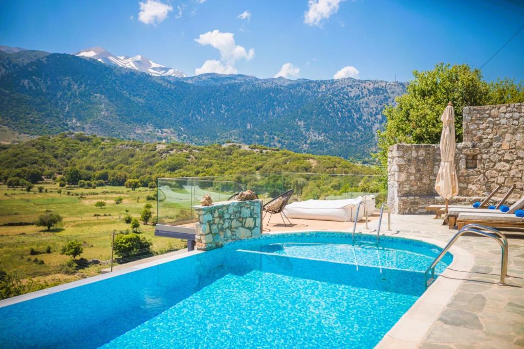 a swimming pool with a view of a mountain at Traditional Villas Askyfou in Karés