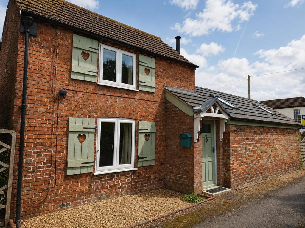 a brick house with two windows and a door at 2 Bed in Partney oc-v44757 in Partney