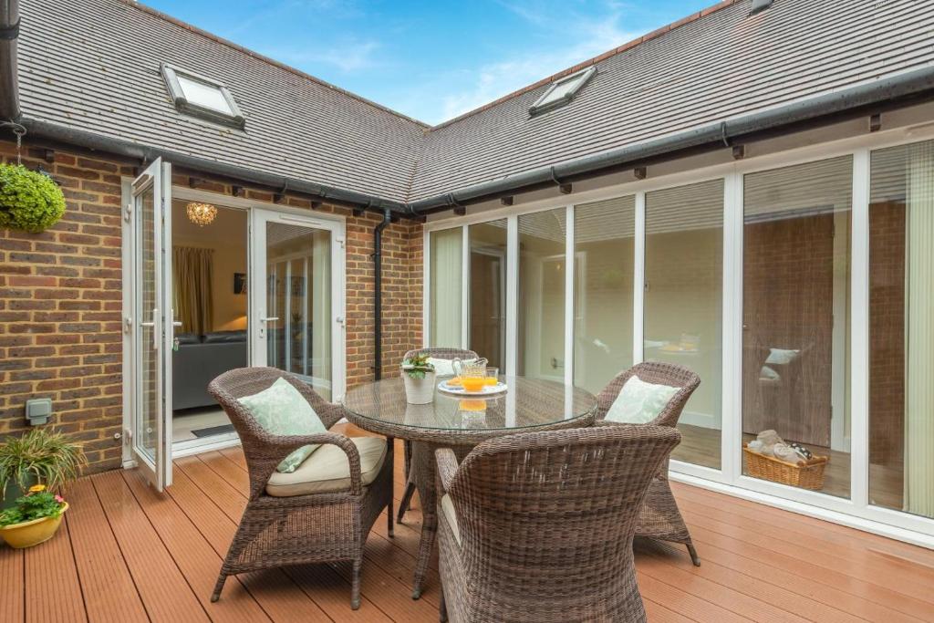 a patio with a table and chairs on a deck at 2 Bed in Buxted oc-t44744 in Buxted