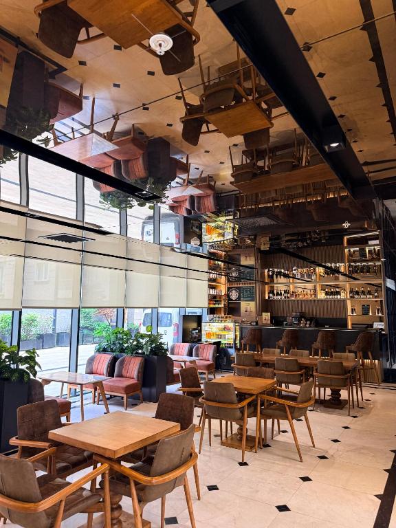 a restaurant with wooden tables and chairs and windows at Cityloft 175 in Istanbul