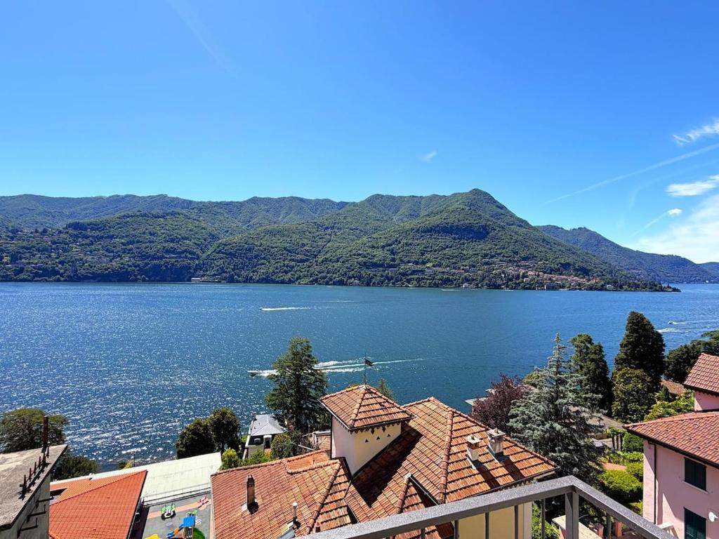 a view of a large body of water with mountains at Cristoforis Lake View House in Carate Urio