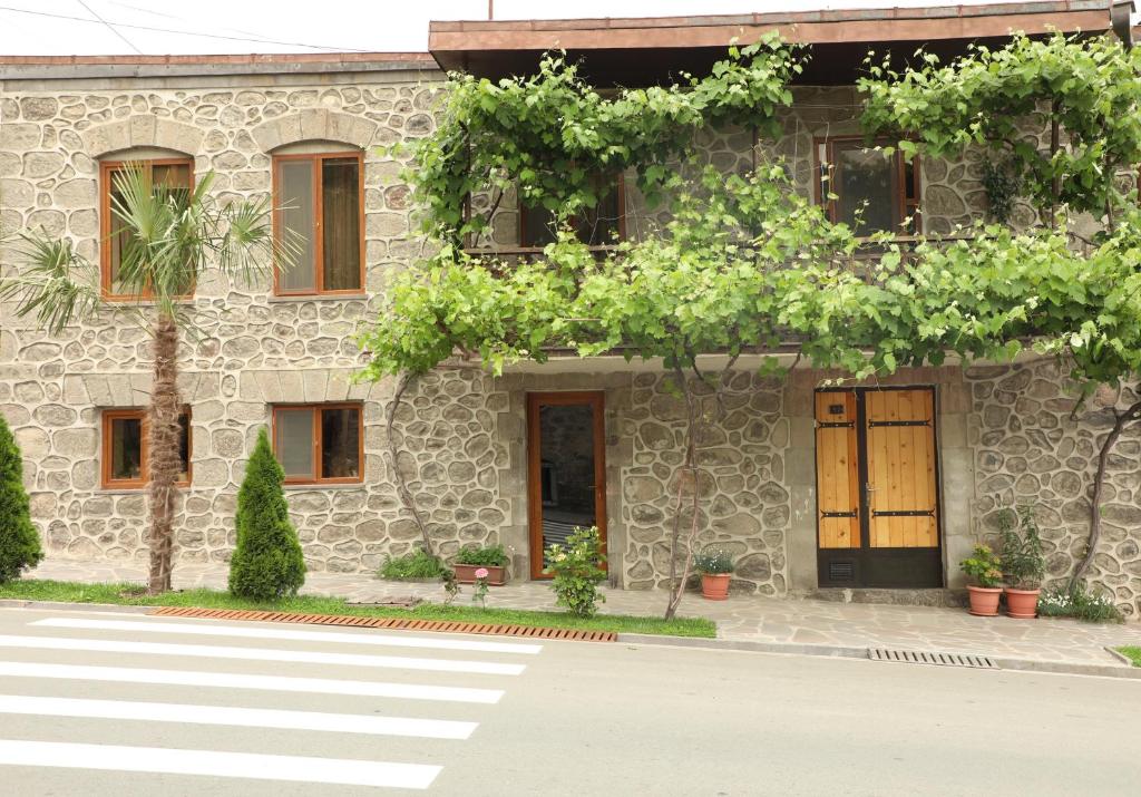 a stone building with a crosswalk in front of it at Guest House 52 in Goris