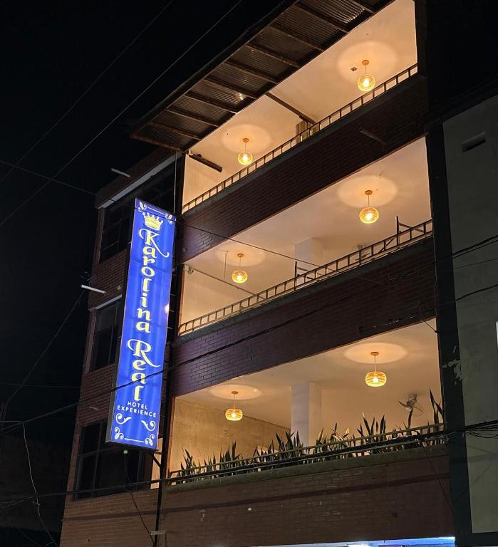 a blue sign on the side of a building at karolina Real Hotel Experience in Apartadó