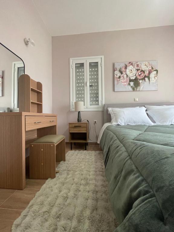 a bedroom with a bed and a dresser and a desk at Stella Collection in Kranidi