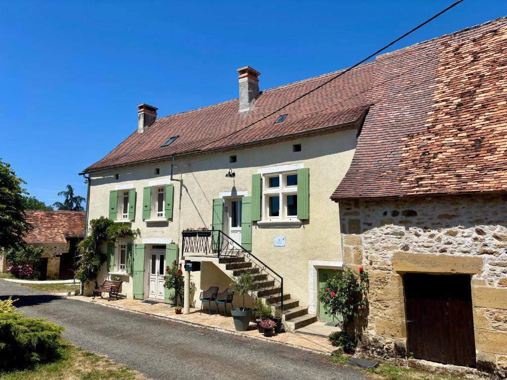 a large house with green and white at Le Charme du Perigord - chambre & table d'hotes in Saint-Sulpice-dʼExcideuil