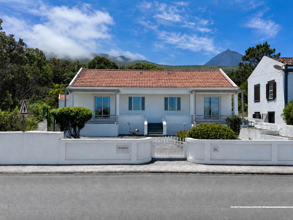 a white house with a red roof at Pico Island Villas 117 - Natural Pools and Incredible Views in São Roque do Pico
