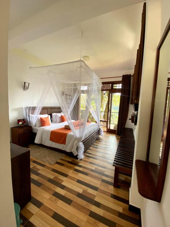 a bedroom with a bed with a mosquito net at Ameliora Ella in Ella