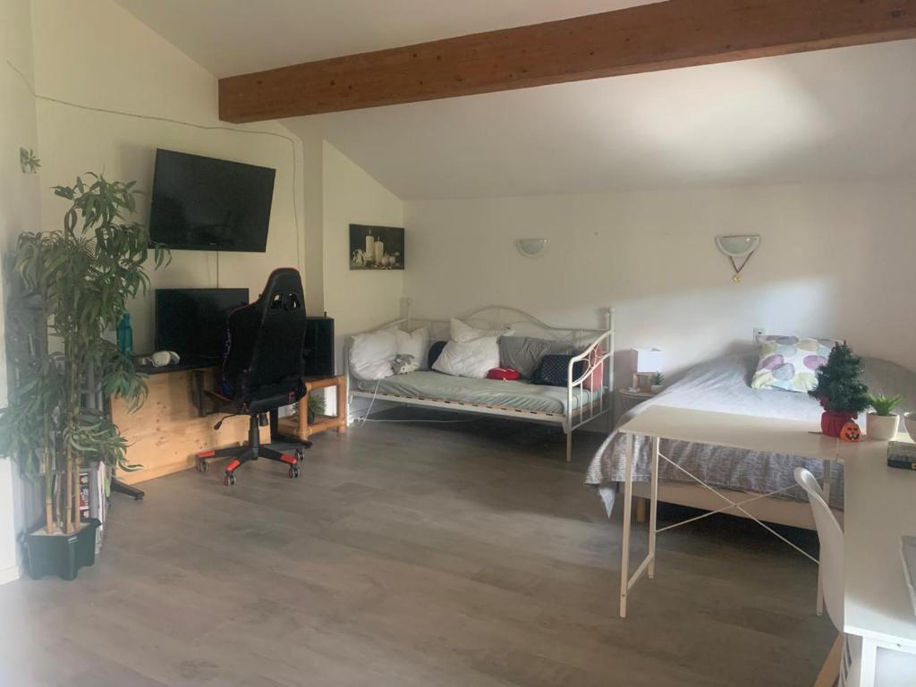a living room with two beds and a couch at Havre de paix in Cluny