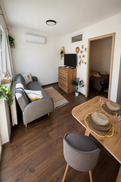 a living room with a couch and a table at Casa Capri Győr in Győr