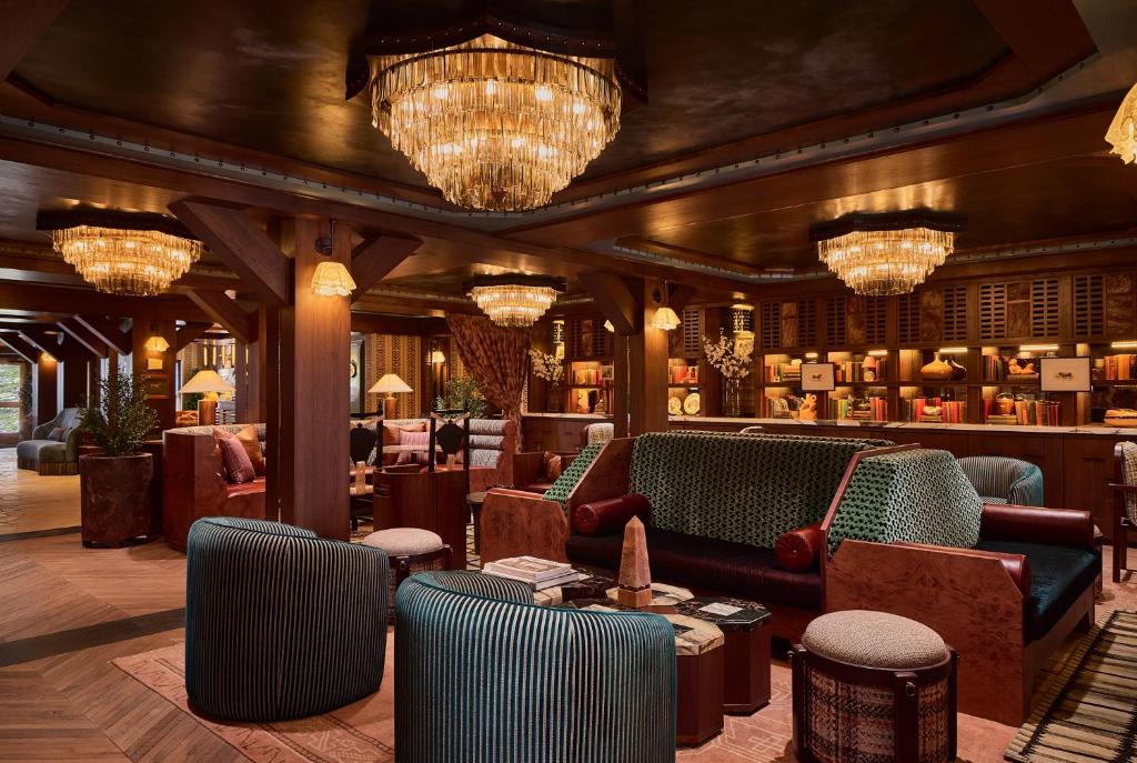a lobby with chairs and tables and chandeliers at Faraway Jackson Hole in Teton Village