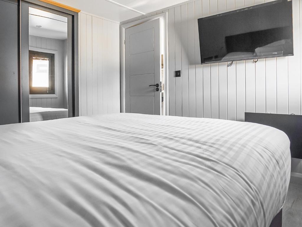 a large white bed in a room with a window at Mandarin Lodge - Uk51936 in Yarm