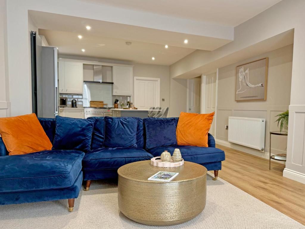 a living room with a blue couch and a table at Stone's Throw in Richmond