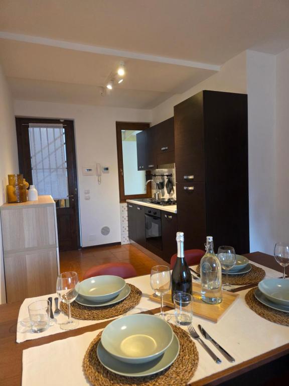 a dining table with plates and wine glasses on it at La Tana - Borno Holiday in Borno