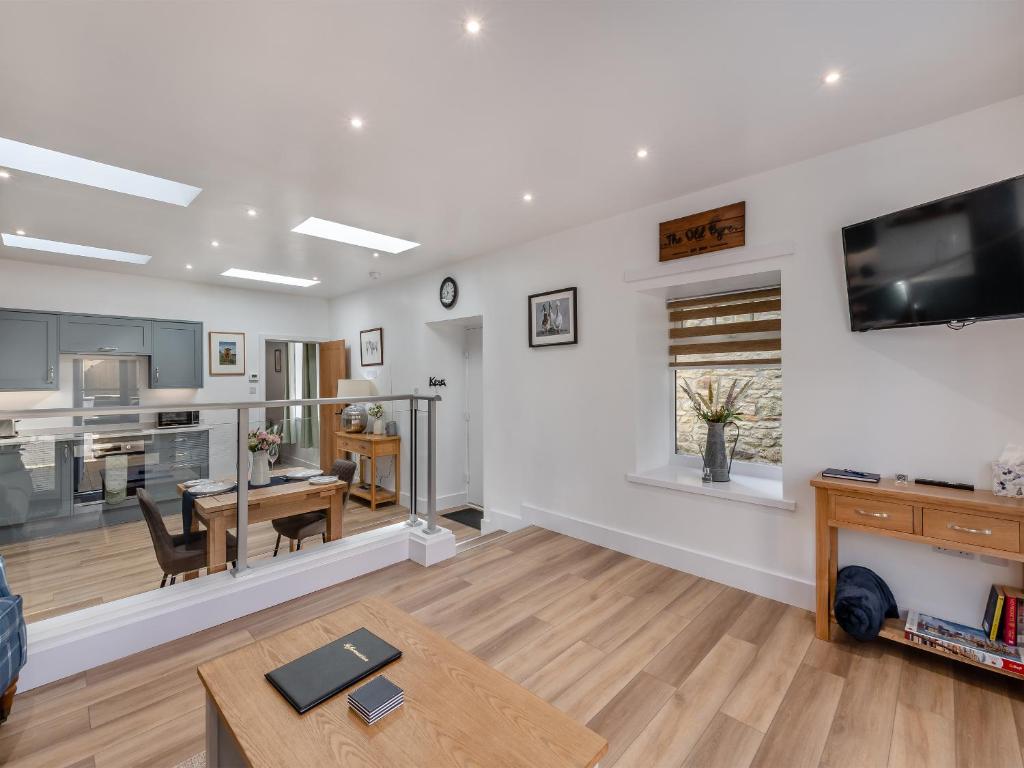 a living room with a kitchen and a dining room at The Old Byre in Edmondbyers