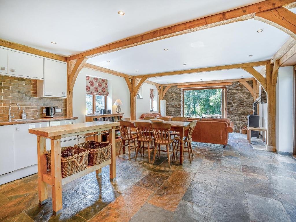 a kitchen and dining room with a table and chairs at Y Beudy - Uk49917 in Penclawdd