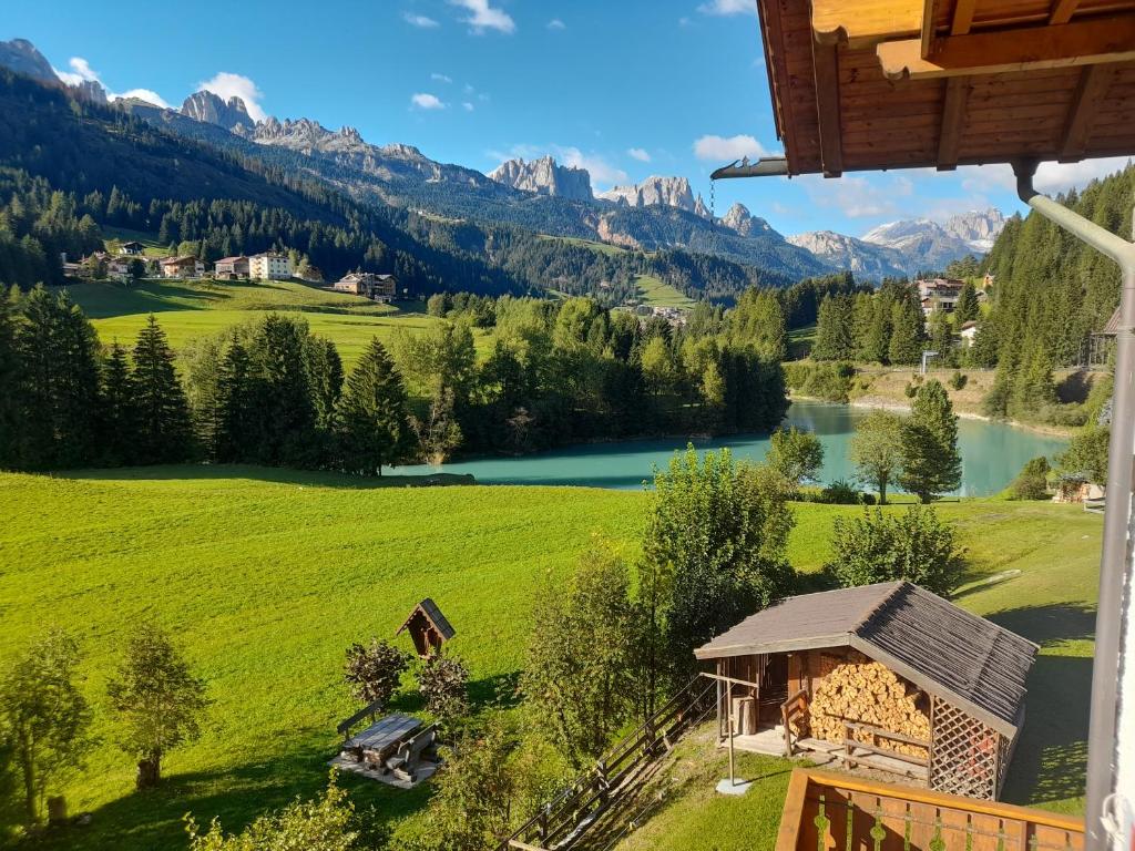 a view of a valley with a lake and mountains at Casa Defrancesco - with Garden in Moena