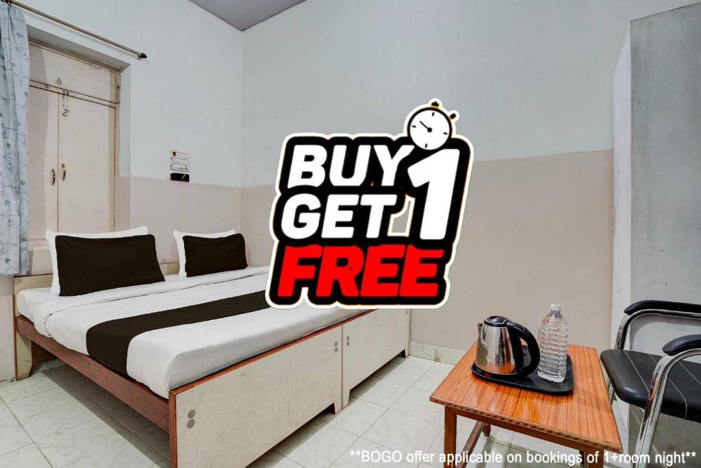 a bedroom with a bed with a buy get free sign on it at Super Hotel O Gaya Railway Station Formerly Vishal Inn in Gaya