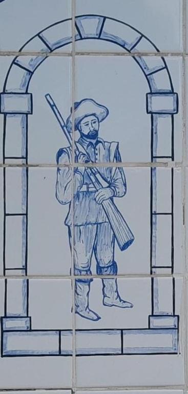 a drawing of a man standing in a doorway at Pousada dos Bandeirantes in Ouro Preto