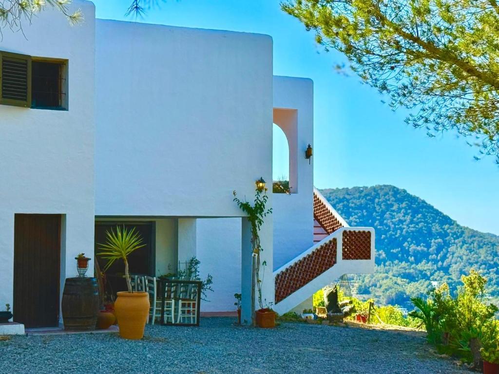 a white house with a staircase on the side of it at Villa Sa Guaita in Sant Josep de sa Talaia