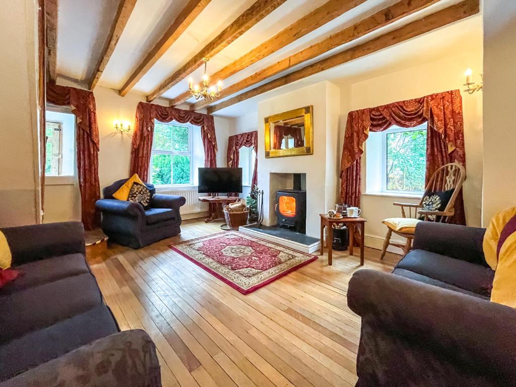 a living room with two couches and a fireplace at Y Ddol in Llansannan