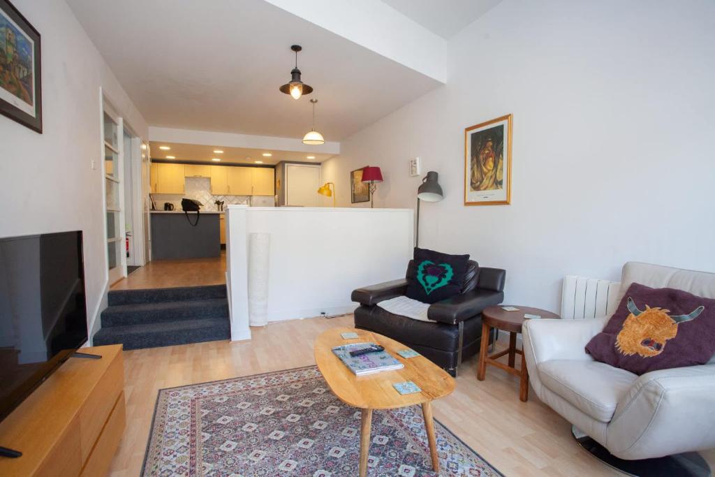 a living room with a couch and a table at The Art Flat Glasgow in Glasgow