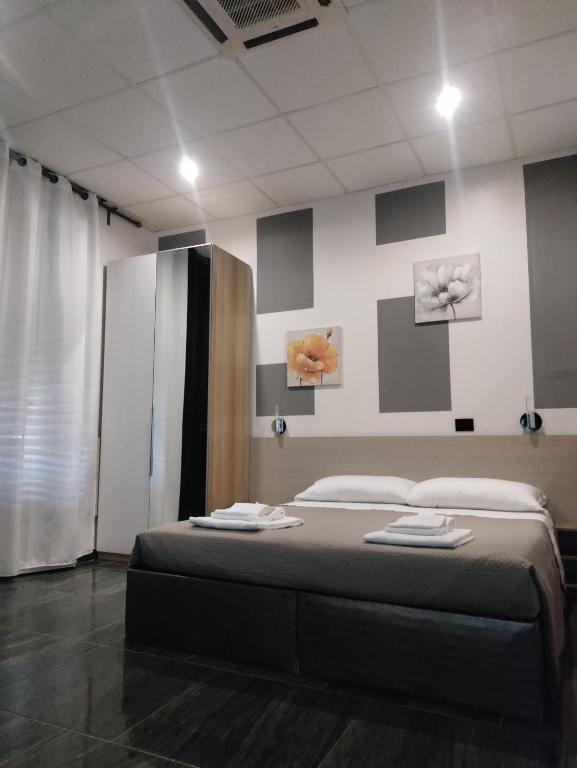 a bedroom with a bed and two paintings on the wall at B&B Adriatico in Giulianova