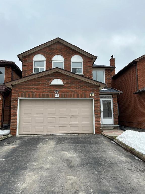 a brick house with a garage at HomeNet in Toronto