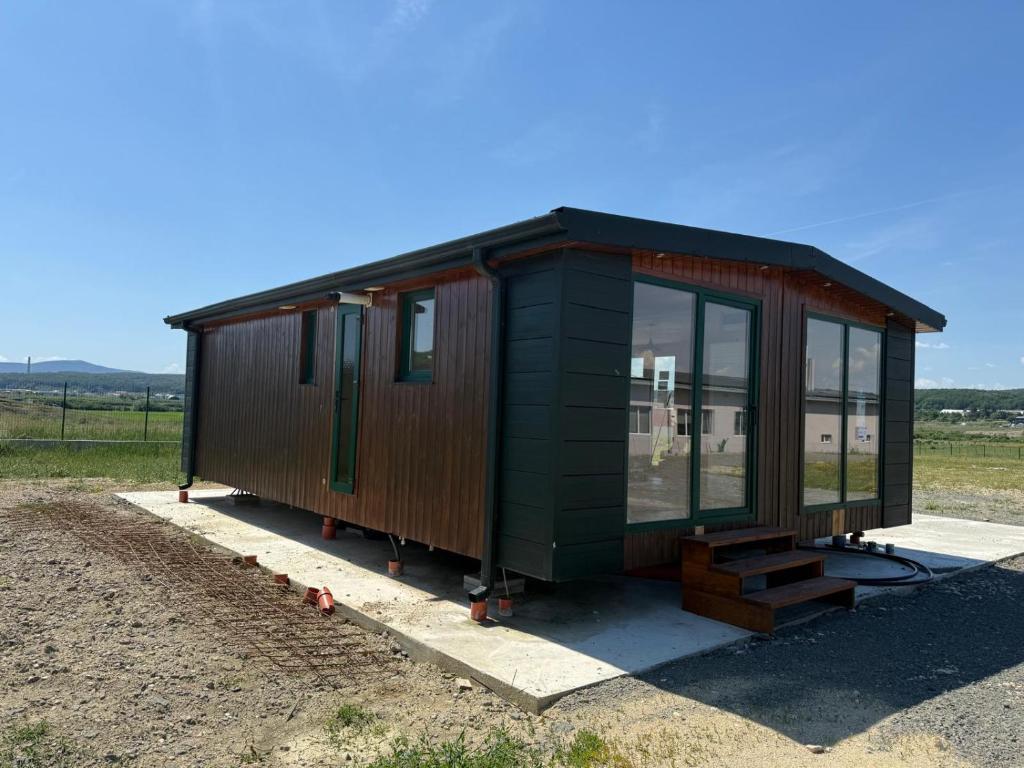 a tiny house on display in a field at Green Camp Resort in Hereclean
